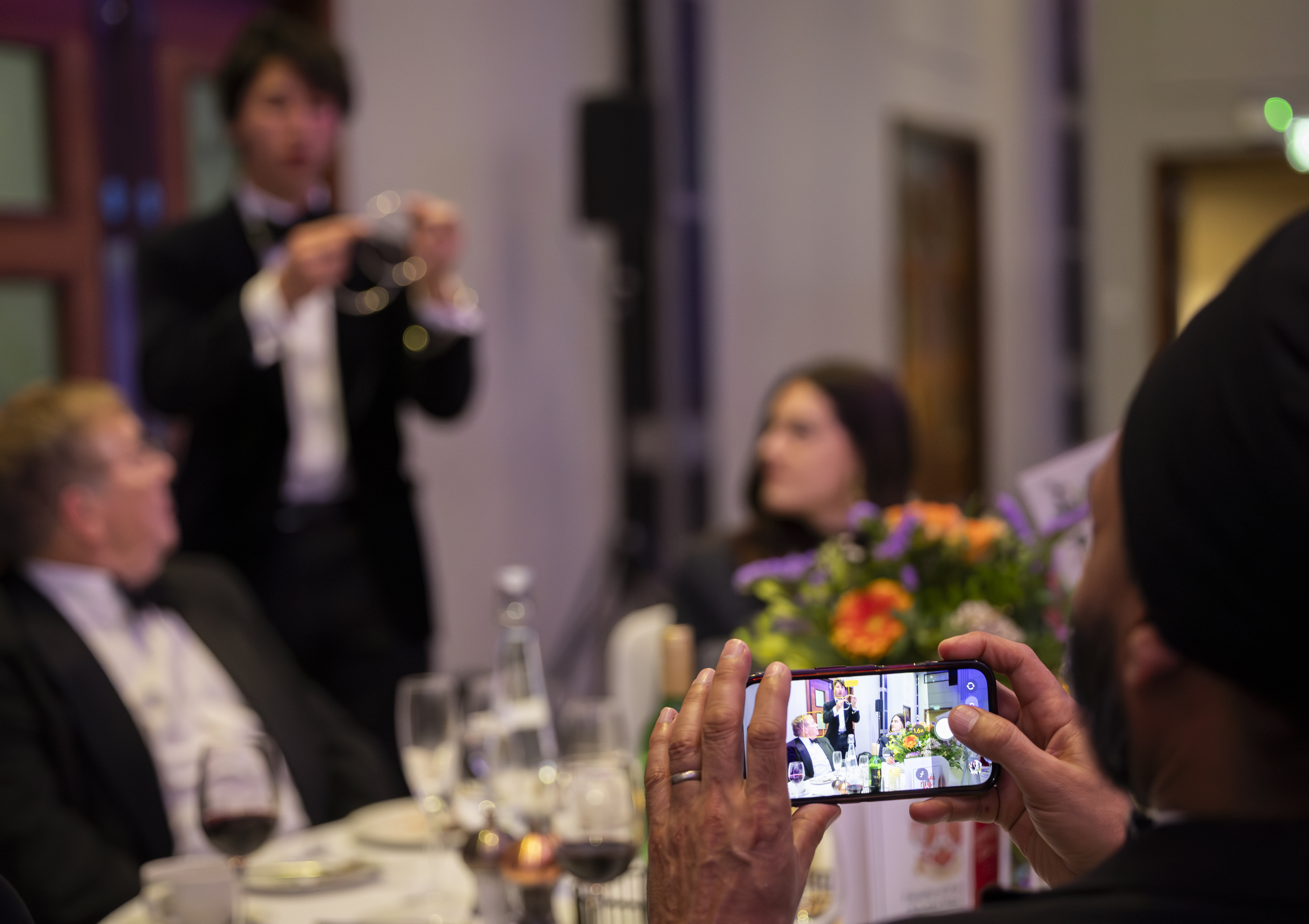 Guests enjoying an informal magic performance